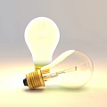 Two Transparent Incandescent Light Bulbs With Golden Bases Standing And Leaning