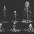 Multiple Water Fountains Displaying Various Spray Heights And Circular Water Ripples