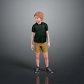 Red Haired Boy In Green T Shirt Yellow Shorts And Black Shoes Against Grey Background