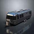 Silver Modern Travel Trailer with Solar Panels on Roof and Reflective Surface
