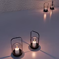 Decorative Ornament Set With Glass Lanterns Black Metal Handles Lit White Candles And Light Shadows