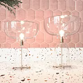 Glass Table Lamps With Golden Base On Colorful Terrazzo Countertop And Pink Hexagonal Tile Wall