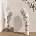 Textured White Floor Lamp With Stacked Pedestal Against Neutral Wall And Leafy Branch