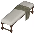 White Padded Bench With Brown Wooden Legs And Green Draped Blanket