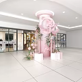 Pink Sculpture Carving In Hall With Floral Arrangements And White Boxes Near Glass Doors And Store