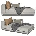 Modern Comfortable Light Toned Chaise Lounge With Beige Gray Pillows And Gray Blanket