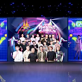 Youth With You Cast Group Photo on Stage With Neon Lights and Colorful Background Design