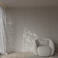 Modern Curved Single Sofa With White Cushion Against Light Colored Walls And White Curtains
