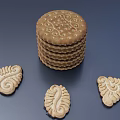 Golden Stack of Round Cookies with Decorative Patterns and Assorted Shapes on Dark Background