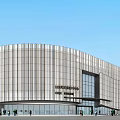 Modern Museum Building With Curved Exterior Design Glass Facade Lighting Effects And Surrounding Pedestrians Trees