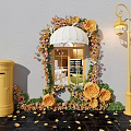 Scenic Photo Spot With Floral Arch White Awning Yellow Postbox And Street Lamp