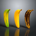 Three Bananas at Different Ripening Stages Green Yellow and Brown Spots