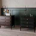 Two Dark Wooden Dressers With Drawers And Decorative Items Against Green Accent Wall