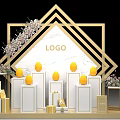 Golden Geometric Frame Exhibition Setup With LOGO White Pedestals Yellow Egg Decor And Floral Arrangements