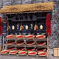 Traditional Dried Goods Stall With Thatched Roof Brick Wall Hanging Items And Bamboo Baskets