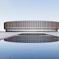 Modern Circular Museum Building Featuring Wooden Striped Facade And Reflecting Pool With Clear Water Reflection