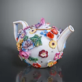 Decorative Porcelain Teapot With Colorful Flowers Vibrant Petals And Green Leaves