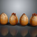 Fresh Cracked Pomegranates with Orange Yellow Textured Surface Arranged on Dark Background with Reflections