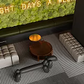 Modern Booth Sofa Setup With Moss Wall Striped Flooring Wooden Coffee Table And Potted Plant