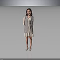 Smiling Woman In Gray Plaid Coat And White Dress Standing Against Gray Background
