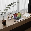 Modern Desk Setup by Window with Potted Plant Headphones Mobile Phone Laptop and Open Notebook