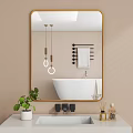 Gold Framed Mirror In Modern Bathroom Reflects Bathtub And Lights