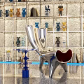 Modern Sculptural Single Chair With Metallic Glossy Finish Decorative Figurines And Textured Wall