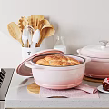 Pink Cookware Collection With Lidded Pots Wooden Utensils And Baking Pastry Bread