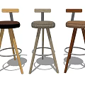 Three Stylish Bar Stools With Different Colored Upholstered Seats And Wooden Frames