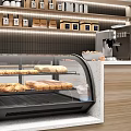 Curved Glass Bakery Display Case With Fresh Bread And Pastries On Wooden Counter