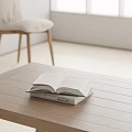 Open Book On Wooden Table With Stacked Books In Minimalist Room