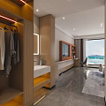Modern Hotel Guest Room With Twin Beds Orange Gray Accent Wall And Cozy Sofa Area