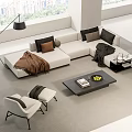 White L Shaped Sofa With Cushions Brown Blanket And Black Coffee Table With Fruit Book