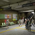 Busy Subway Station Interior With Seats Advertising Boards Escalator And People Walking