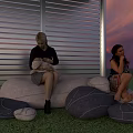 Relaxing Garden Landscape With Two Women On Gray Bean Bag Sofas And Sunset Sky