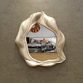 Irregular Curved Edge Mirror With Metallic Finish Reflecting Bedroom Interior On Gray Wall