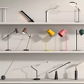 Diverse Modern Table Lamps With Various Designs Colors And Styles On White Shelves