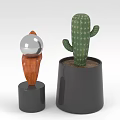 Green Cactus in Black Pot with Decorative Object Featuring Silver Sphere and Brown Wooden Base