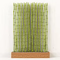 Green Bamboo Stems Arranged In Wooden Frame With Pebble Decoration On Background Wall
