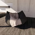 Modern Black Bean Bag Chair With Light Blanket On Wooden Floor And Light Walls