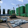 Residential Building Under Construction With Cranes Scaffolding And Materials At Construction Site