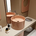 Minimalist Bathroom Interior With Round Pink Basin Mirror And Toiletries On Countertop