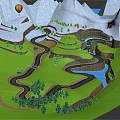 Mountainous Terrain Featuring Snowy Peaks Winding River Green Meadows Trees And Hot Air Balloon