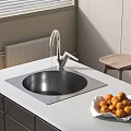 Stainless Steel Kitchen Sink On White Countertop With Faucet And Oranges In Modern Kitchen
