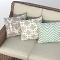 Wicker Outdoor Sofa with Patterned Cushions and Glass Top Coffee Table