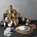 Natural Kitchenware Display On Counter With Wooden Chopping Boards Mortar Pestle And Wicker Baskets