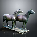 Two Bronze Horse Statues Standing On A Base With Dark Background
