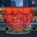 Heart Shaped Red Inflatable Decoration In Outdoor Square With Modern Buildings And Flowers