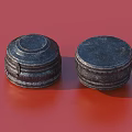 Two Black Round Patterned Decorative Kitchenware Pieces on Red Background