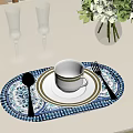 Elegant Dinnerware Set with Cup Plate Spoon Fork and Champagne Glasses on Blue White Placemat